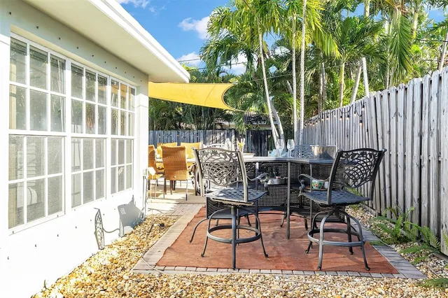 a view of a chairs and table in backyard