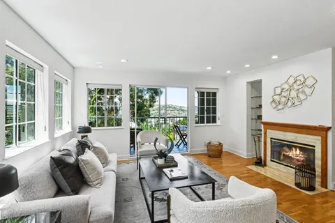 a living room with furniture and large windows