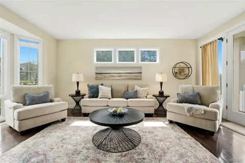 a living room with furniture a rug and a window