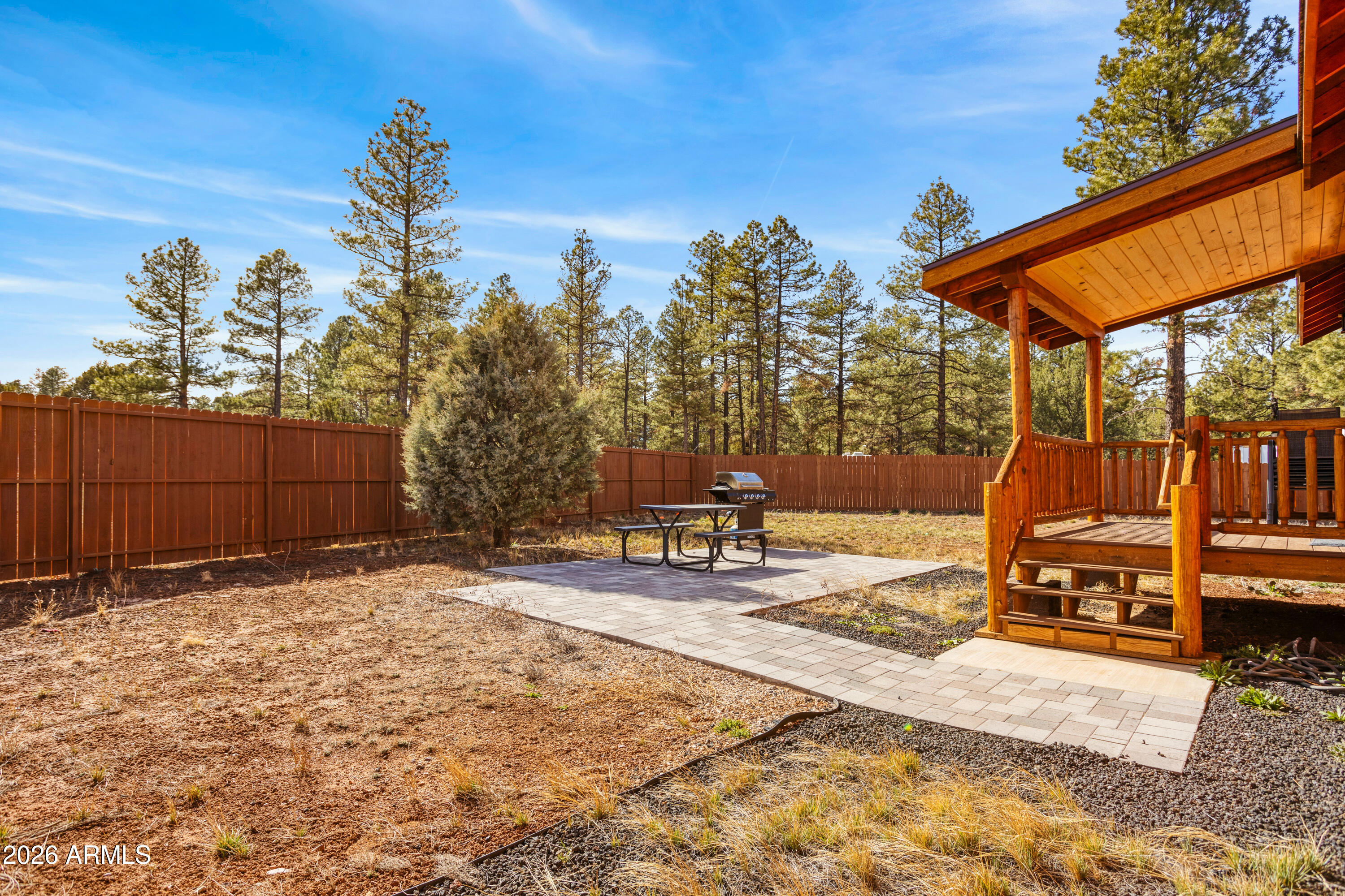 2718 Church Lane Overgaard, AZ 85933 - Photo 32 of 51 a backyard of a house with barbeque oven table and chairs