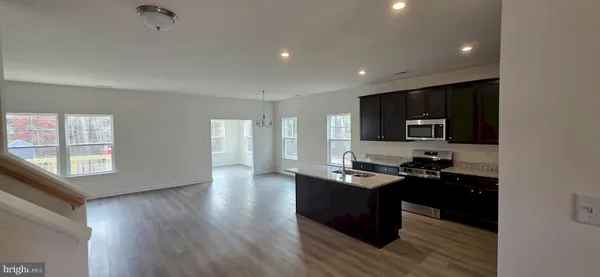 a kitchen with granite countertop a stove and a sink