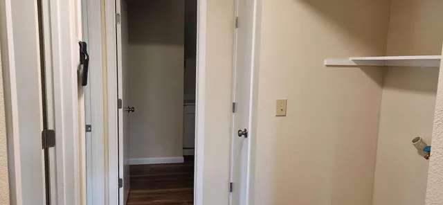 a view of empty room with wooden floor