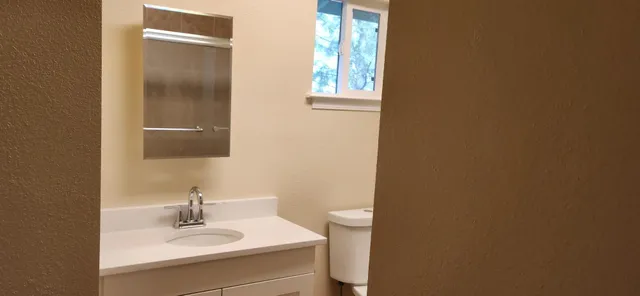 a white toilet sitting next to a bathroom sink