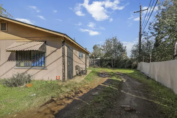 a front view of a house with a yard and trees