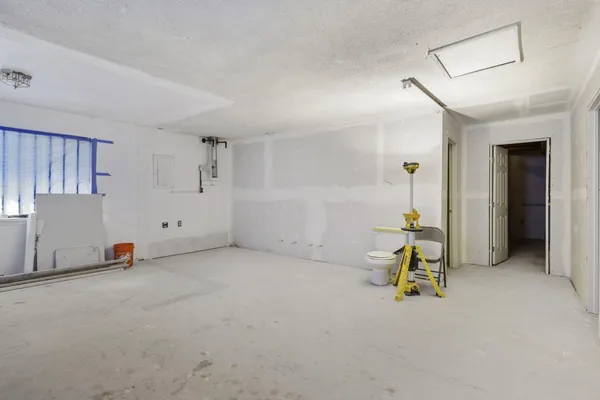 a view of a room with furniture and a chandelier