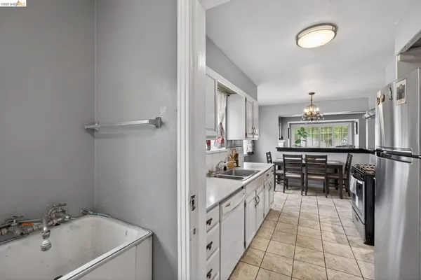 a kitchen with stainless steel appliances granite countertop a stove and a refrigerator