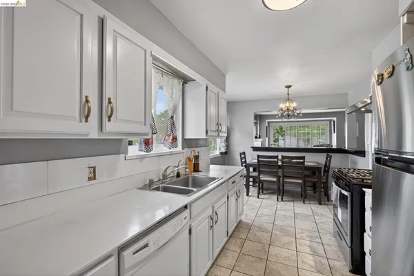 a kitchen with stainless steel appliances granite countertop a stove oven and a refrigerator