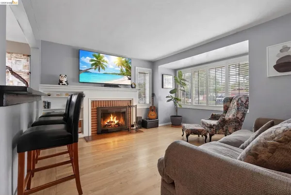 a living room with furniture a window and a fireplace