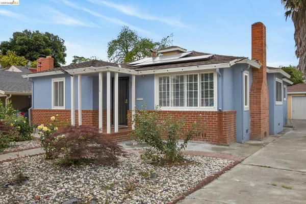 a backyard of a house with table and chairs