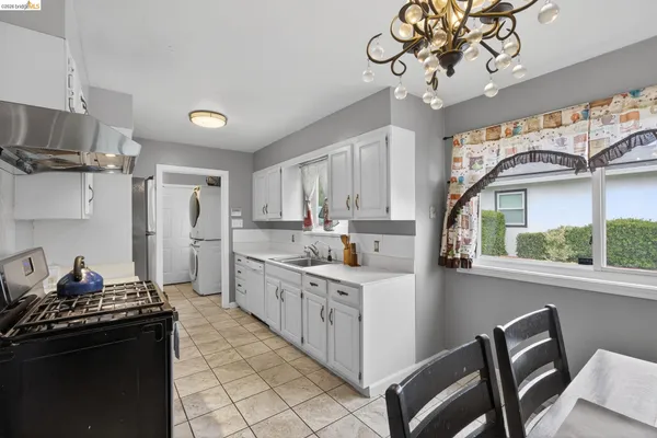a kitchen with a sink appliances and cabinets