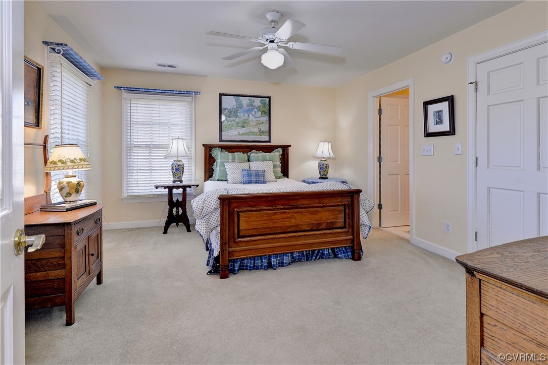 101 Spring Branch Williamsburg, VA 23185 - Photo 23 of 44 a bedroom with a bed and a chandelier
