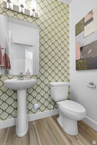 3074 South 270 West Logan, UT 84321 - Photo 12 of 30 Pedestal sink with chrome faucet, toilet, and wood-finish flooring