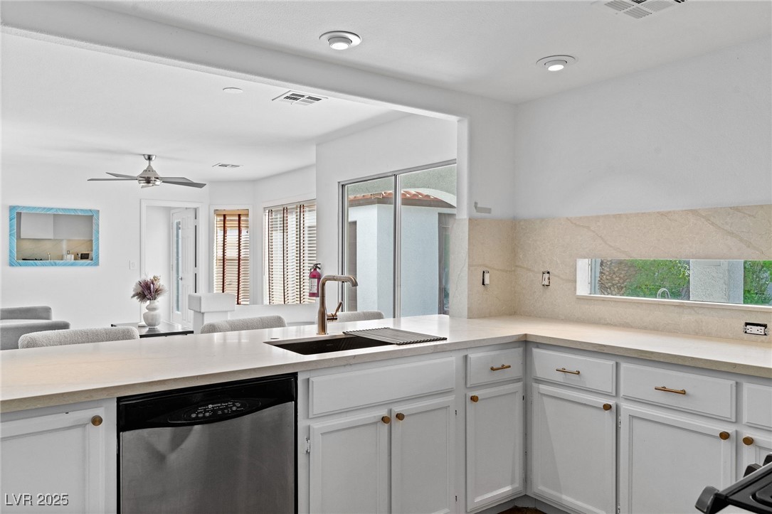 2829 Via Florentine Street Henderson, NV 89074 - Photo 48 of 48 Kitchen featuring white cabinets, stainless steel dishwasher, open floor plan, and a ceiling fan