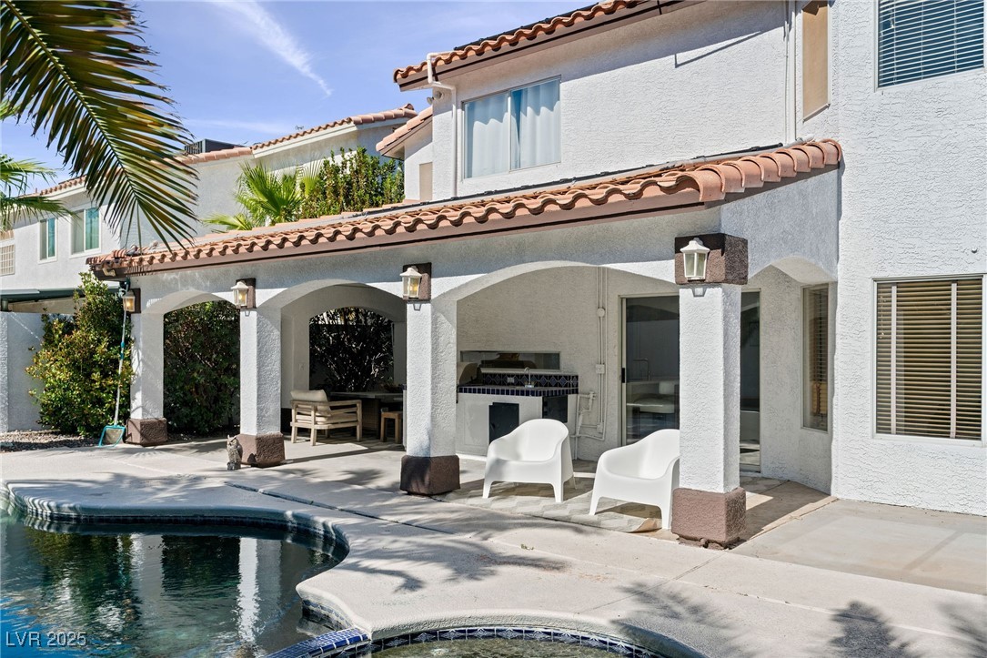 2829 Via Florentine Street Henderson, NV 89074 - Photo 19 of 48 Rear view of house with stucco siding, an outdoor pool, a patio area, and a tile roof