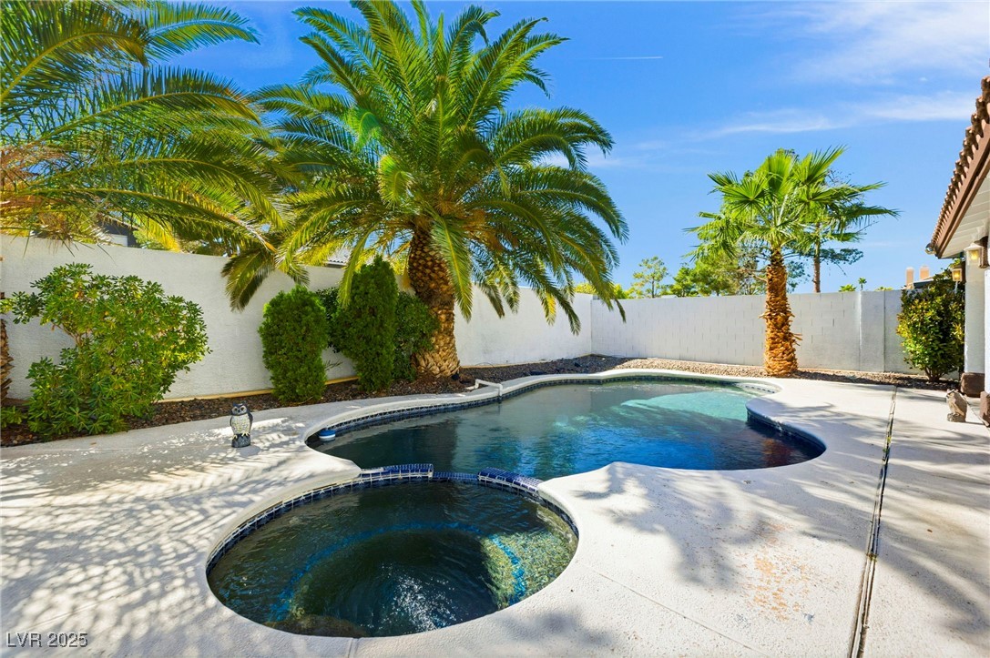 2829 Via Florentine Street Henderson, NV 89074 - Photo 2 of 48 View of swimming pool featuring a fenced backyard, a pool with connected hot tub, and a patio