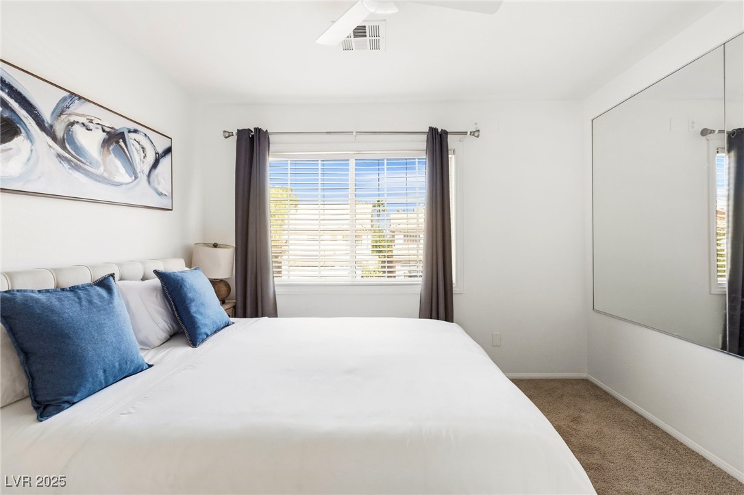 2829 Via Florentine Street Henderson, NV 89074 - Photo 23 of 48 Carpeted bedroom featuring multiple windows and a ceiling fan