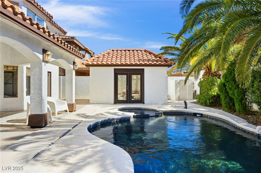 2829 Via Florentine Street Henderson, NV 89074 - Photo 3 of 48 View of swimming pool with a pool with connected hot tub, a patio, an outbuilding, and french doors
