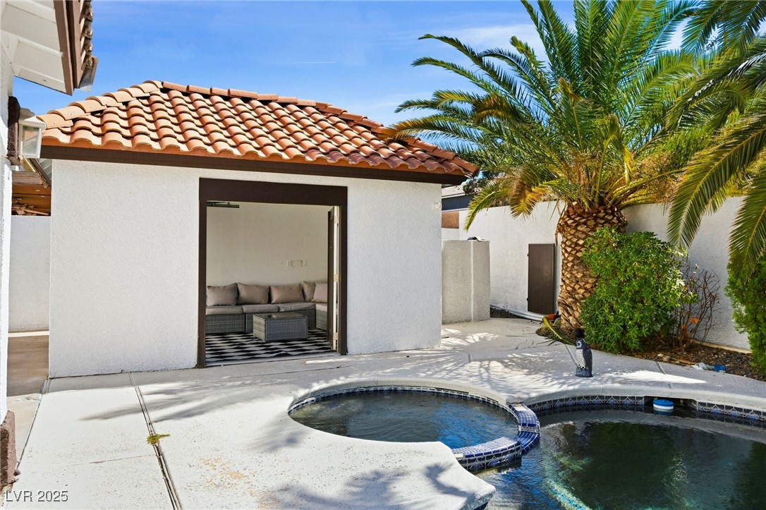 2829 Via Florentine Street Henderson, NV 89074 - Photo 4 of 48 View of pool featuring a patio, a pool with connected hot tub, and an outdoor structure
