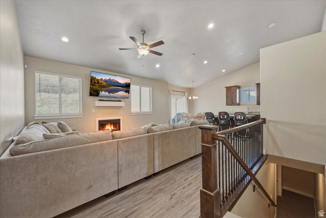45 Memory Lane Tooele, UT 84074 - Photo 5 of 30 Living room with ceiling fan, light wood-style flooring, lofted ceiling, recessed lighting, and fireplace