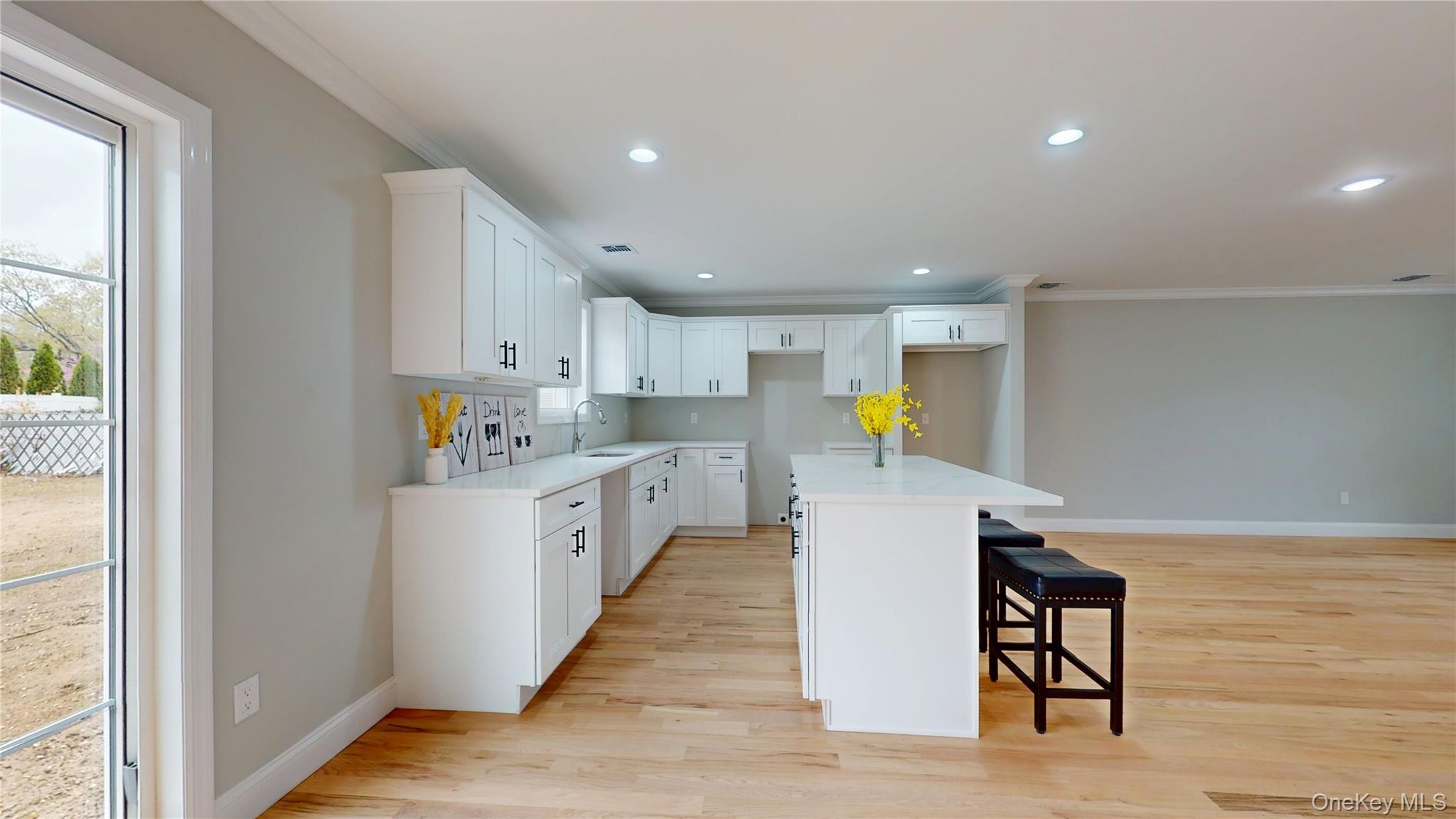 492 Blue Point Road Farmingville, NY 11738 - Photo 8 of 21 a kitchen with a refrigerator and wooden floor