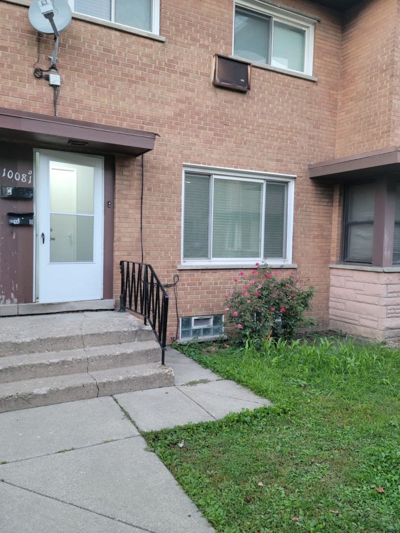 10081 Frontage Road, Unit D Skokie, IL 60077 - Photo 1 of 12 a view of a house with brick walls and a yard with couches