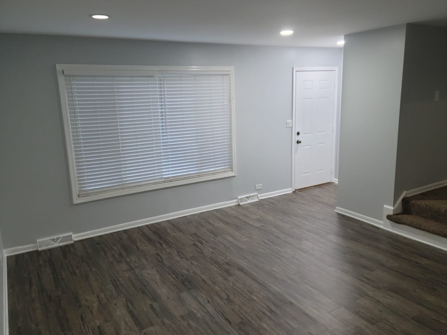 10081 Frontage Road, Unit D Skokie, IL 60077 - Photo 3 of 12 an empty room with wooden floor and windows