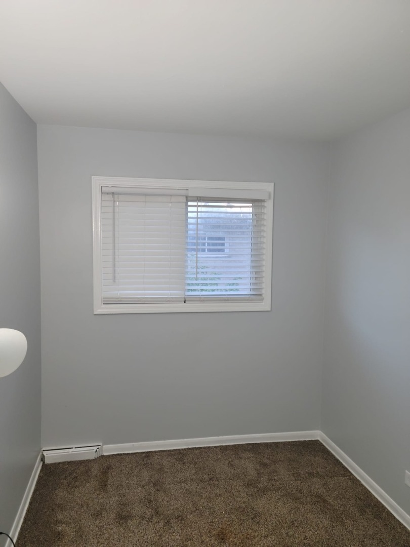 10081 Frontage Road, Unit D Skokie, IL 60077 - Photo 5 of 12 an empty room with a window