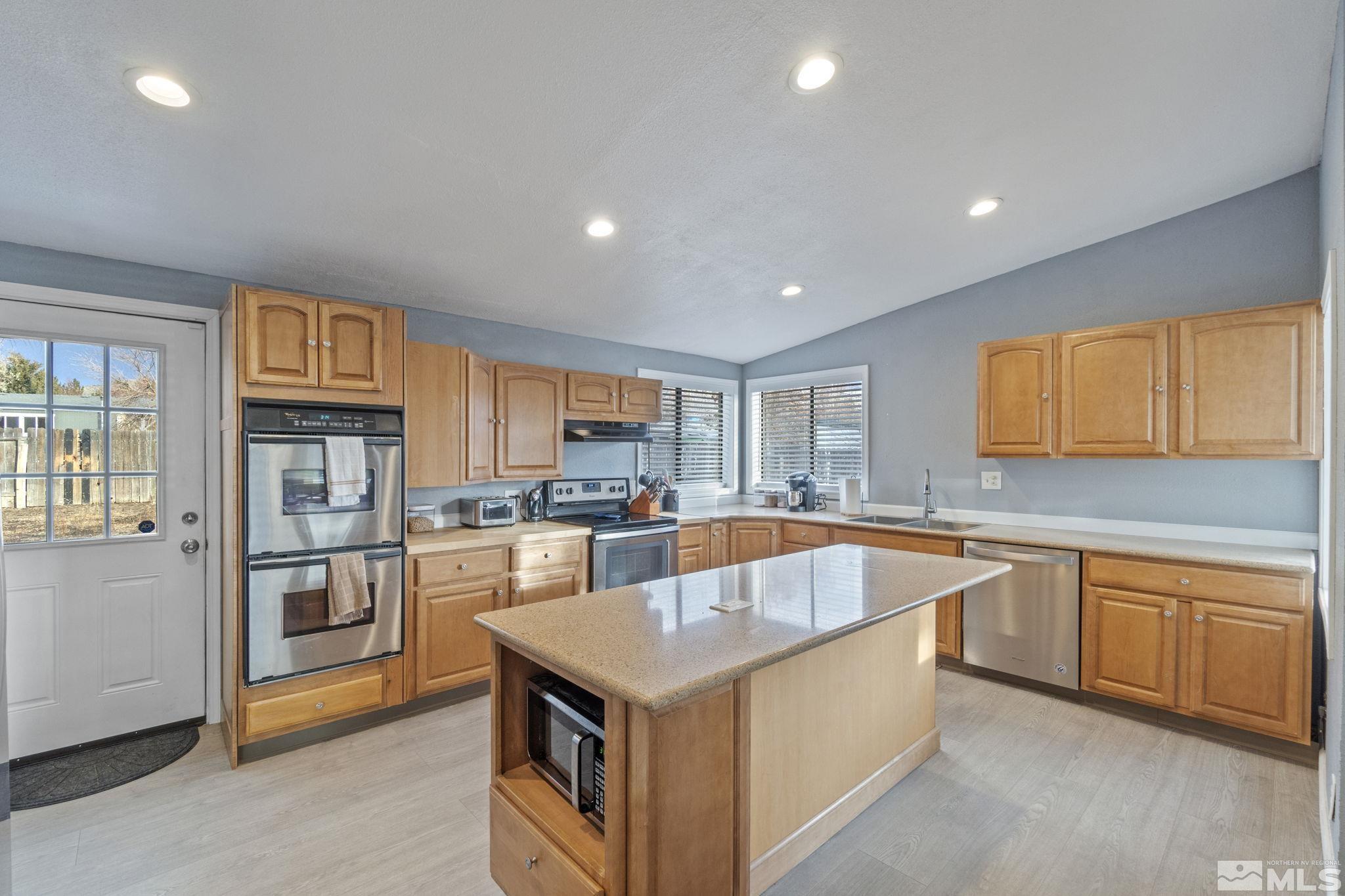 3940 Macaw Lane Reno, NV 89508 - Photo 16 of 35 a kitchen with stainless steel appliances granite countertop a stove and a sink