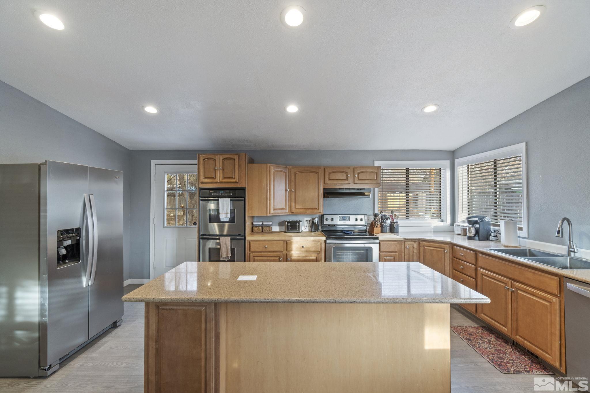3940 Macaw Lane Reno, NV 89508 - Photo 20 of 35 a large kitchen with kitchen island a sink stove and refrigerator