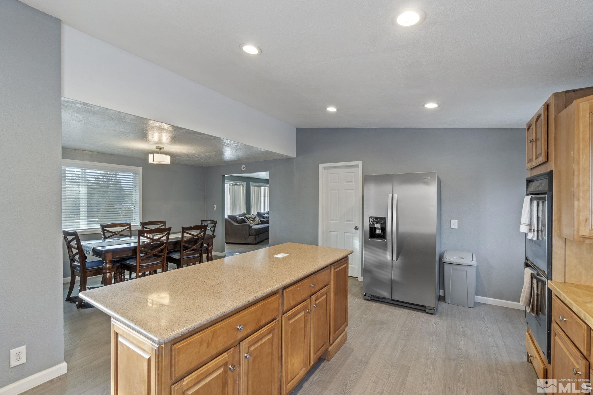 3940 Macaw Lane Reno, NV 89508 - Photo 21 of 35 a large kitchen with sink a refrigerator and chairs