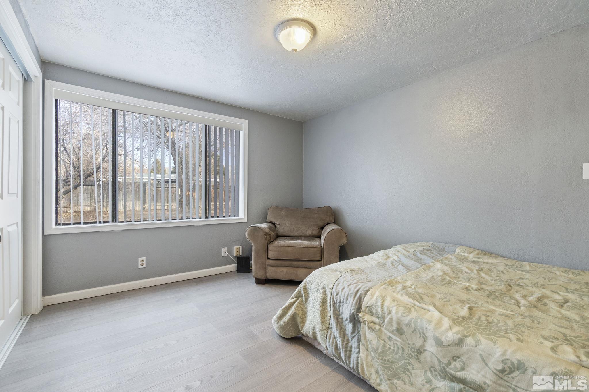 3940 Macaw Lane Reno, NV 89508 - Photo 25 of 35 a bedroom with a bed and a large window