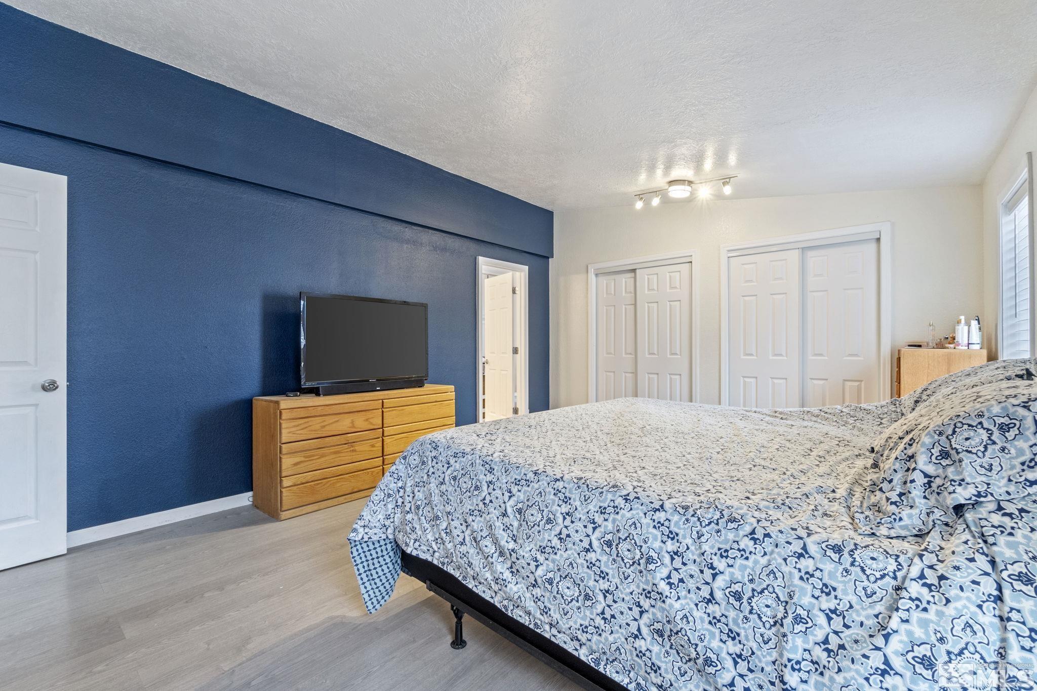 3940 Macaw Lane Reno, NV 89508 - Photo 27 of 35 a living room with a bed furniture and a flat screen tv