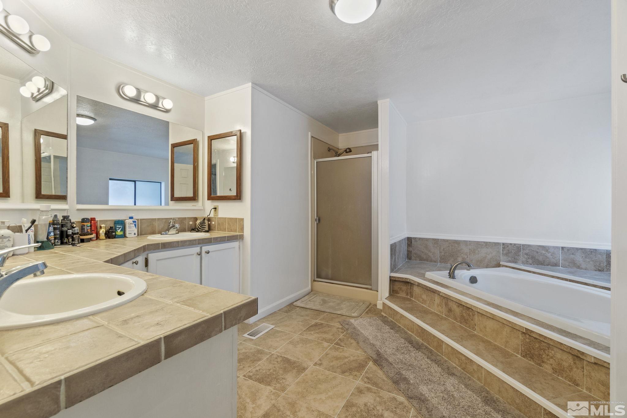 3940 Macaw Lane Reno, NV 89508 - Photo 28 of 35 a spacious bathroom with a tub sink and mirror