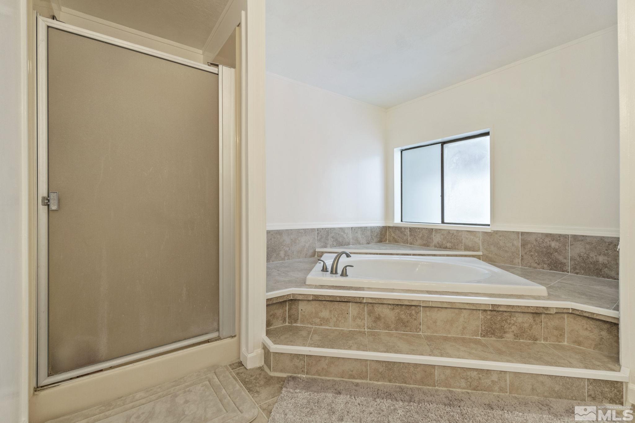 3940 Macaw Lane Reno, NV 89508 - Photo 29 of 35 a bathroom with a bathtub and a shower