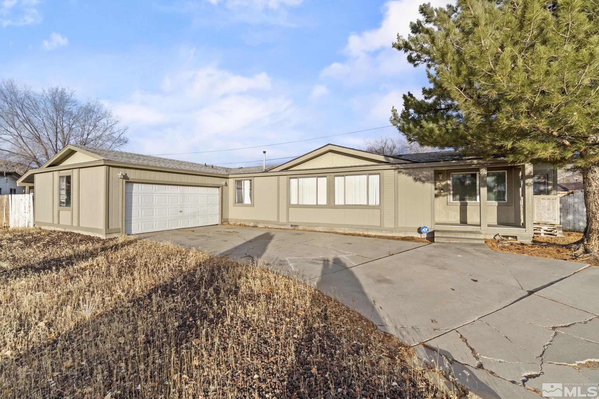 3940 Macaw Lane Reno, NV 89508 - Photo 4 of 35 a front view of a house with a yard and garage