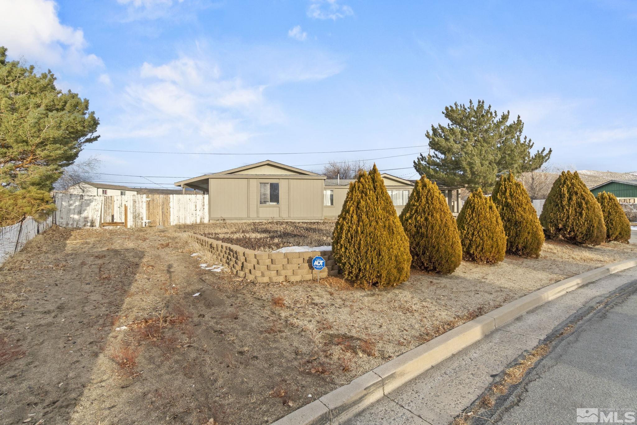 3940 Macaw Lane Reno, NV 89508 - Photo 7 of 35 a view of a house with large trees
