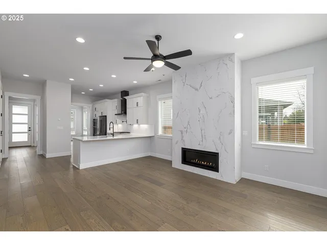a view of kitchen with refrigerator and window