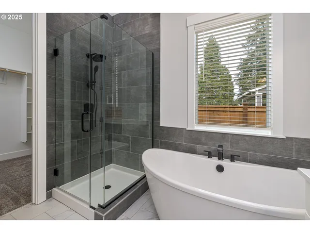 a bathroom with a bathtub and a shower