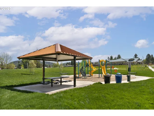 a view of a park with swings and a table