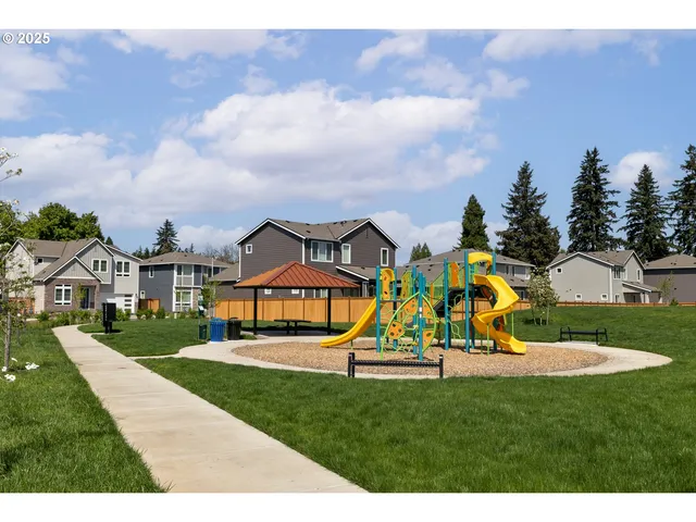 a view of a park with swings and slides