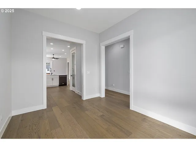a view of an empty room and wooden floor