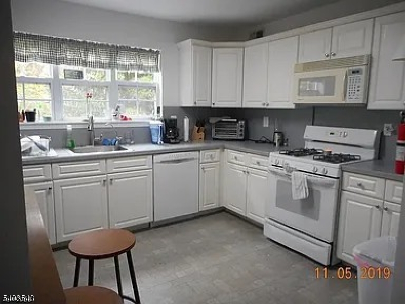 1 Leigh Road Hillsborough, NJ 08844 - Photo 2 of 3 a kitchen with a sink cabinets and window