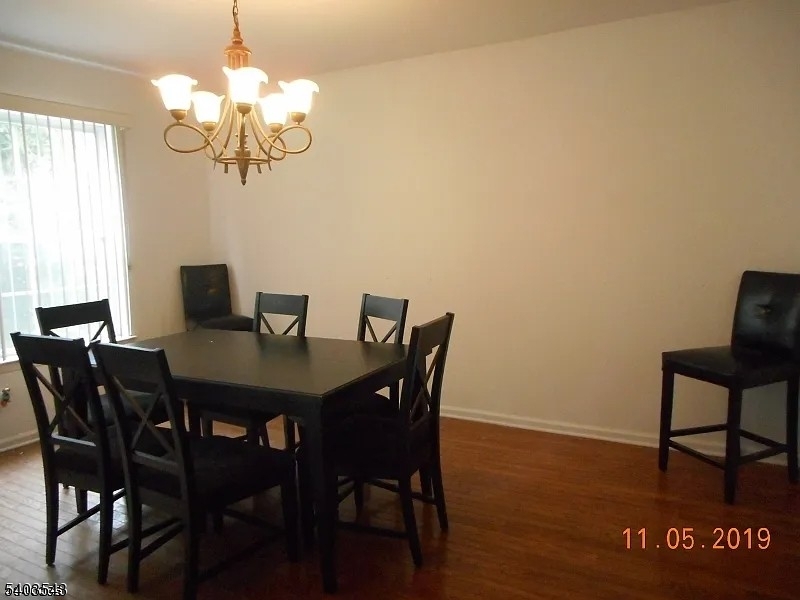 1 Leigh Road Hillsborough, NJ 08844 - Photo 4 of 7 a view of a dining room with furniture a chandelier and wooden floor