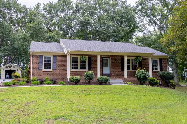 a front view of a house with garden and porch