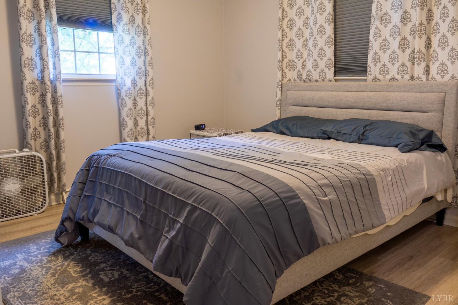 14611 Leesville Road Evington, VA 24550 - Photo 14 of 30 a bedroom with a bed and window