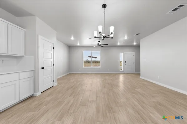a kitchen with cabinets and stainless steel appliances