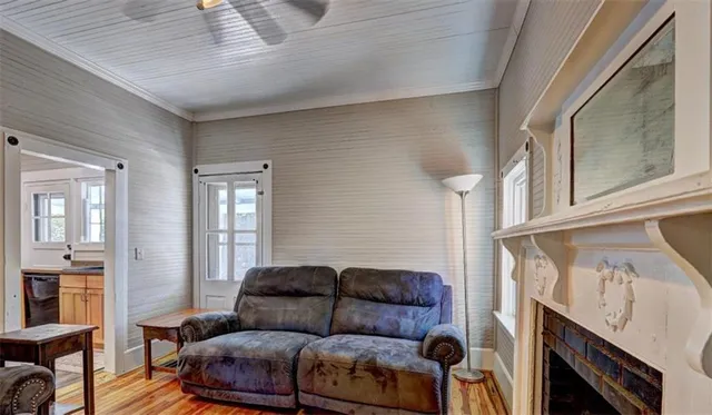 a view of a livingroom with a fireplace a chandelier and wooden floor