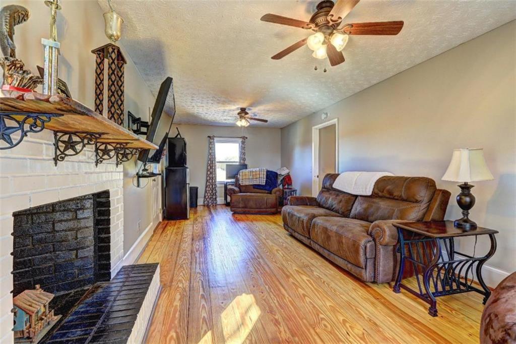 2870 Prospect Road Rutledge, GA 30663 - Photo 38 of 100 a living room with furniture a fireplace and wooden floor