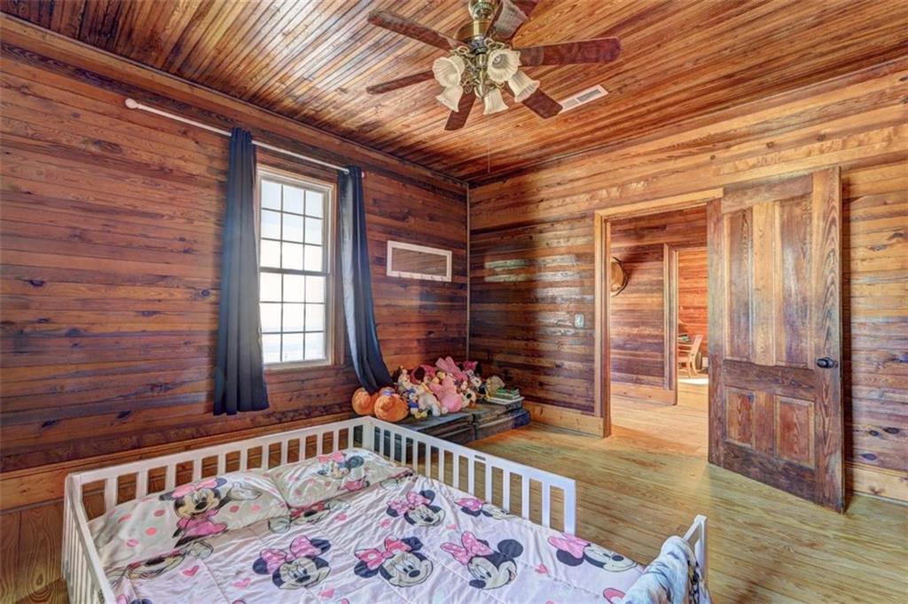 2870 Prospect Road Rutledge, GA 30663 - Photo 57 of 100 a bedroom with furniture and wooden floor