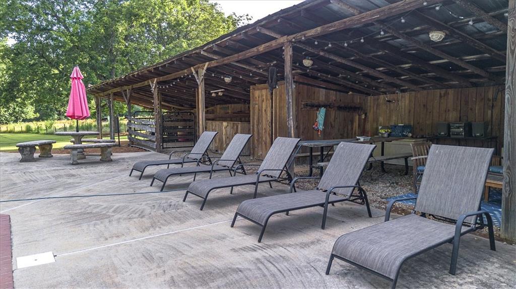 2870 Prospect Road Rutledge, GA 30663 - Photo 66 of 100 a view of a patio with a dining table and chairs with wooden floor and fence